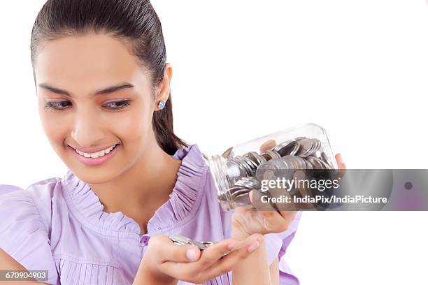 smiling teenage girls emptying money bank - gullak bildbanksfoton och bilder