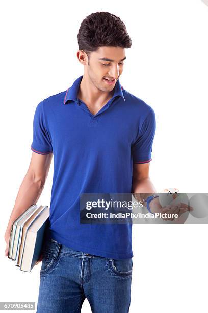 a young student holding books in one hand and piggy bank in the other - gullak bildbanksfoton och bilder