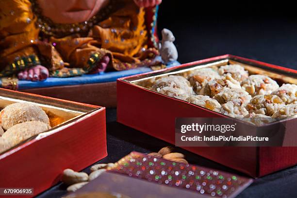 sculpture of ganesha with sweets , indian sweet - mithai stock pictures, royalty-free photos & images