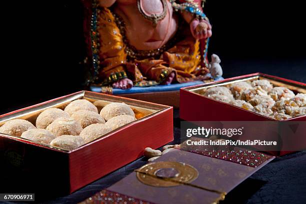 sculpture of ganesha with sweets , indian sweet - laddoo stock pictures, royalty-free photos & images