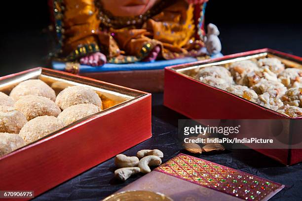 sculpture of ganesha with sweets , indian sweet - laddoo stock pictures, royalty-free photos & images