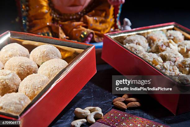 sculpture of ganesha with sweets , indian sweet - laddoo stock pictures, royalty-free photos & images