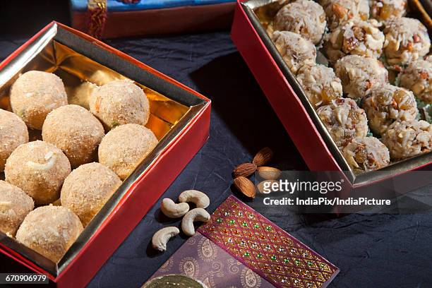 sculpture of ganesha with sweets , indian sweet - laddoo stock pictures, royalty-free photos & images