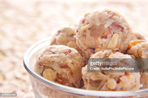 close up of ladoos in a glass bowl , indian sweet - laddoo stock pictures, royalty-free photos & images