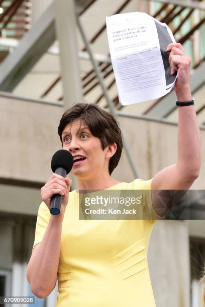 Alison Thewliss MP holds up a copy of the eight-page form affected women are expected to fill in, as she leads the protest outside the Scottish...