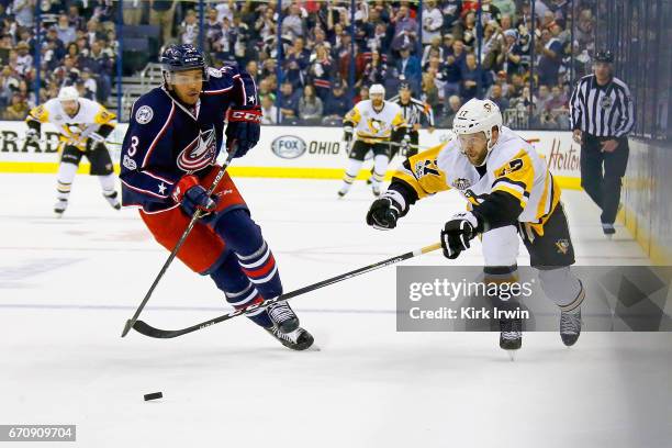 Seth Jones of the Columbus Blue Jackets and Bryan Rust of the Pittsburgh Penguins chase after the puck in Game Four of the Eastern Conference First...