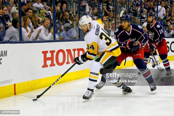 Olli Maatta of the Pittsburgh Penguins attempts to keep the puck away from Seth Jones of the Columbus Blue Jackets in Game Four of the Eastern...