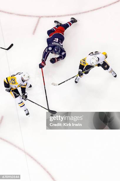 Scott Wilson of the Pittsburgh Penguins attempts to keep the puck away from Markus Nutivaara of the Columbus Blue Jackets in Game Four of the Eastern...