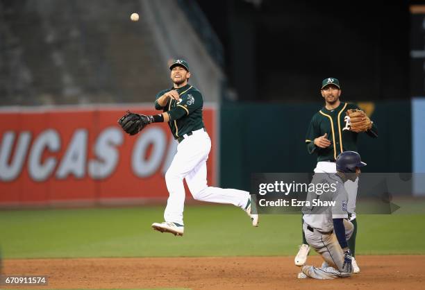 Jed Lowrie of the Oakland Athletics turns an unassisted double play as Jarrod Dyson of the Seattle Mariners slides in to second base on a ball hit by...