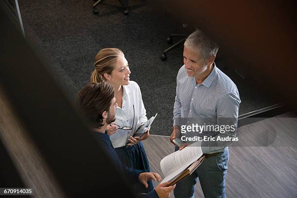 business executives talking to each other in an office - office cabin stockfoto's en -beelden