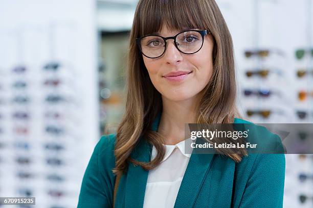 portrait of happy young businesswoman smiling in office - blonde glasses stock-fotos und bilder