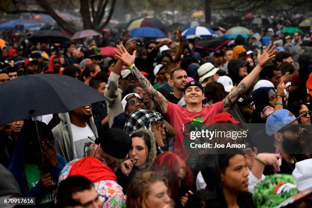 April 20: Happy people in the rain after lighting up at the Denver 420 Rally at Civic Center Park in downtown Denver.April 20 Denver, Colorado.