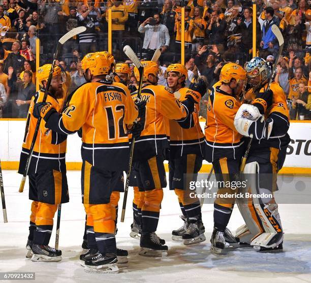 Goalie Pekka Rinne of the Nashville Predators, far right, celebrates with teammates after a 4-1 victory over the Chicago Blackhawks in Game Four of...