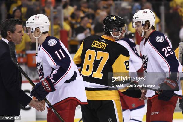 Pittsburgh Penguins Center Sidney Crosby shakes hands with Columbus Blue Jackets center William Karlsson as Pittsburgh Penguins head coach Mike...