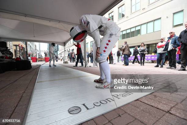 Canadian Fencing Olympian Maxime Brinck-Croteau pretends to be out of breath during an outdoor demonstration on Sparks Street during the Medley on...