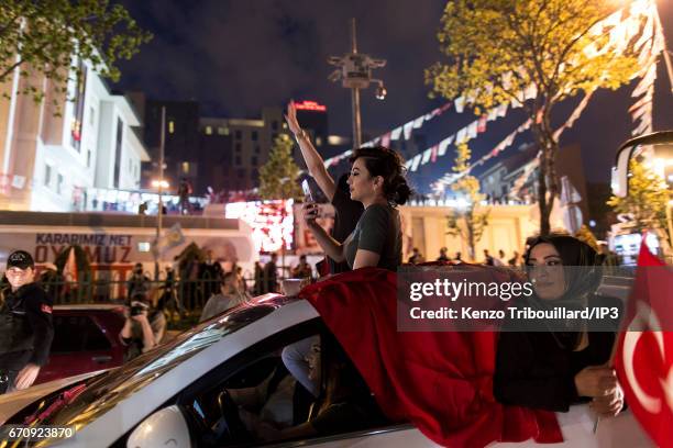 Militants of the conservative AKP party celebrate the victory of yes 'evet', in front of the seat of their party on April 16, 2017 in Istanbul,...