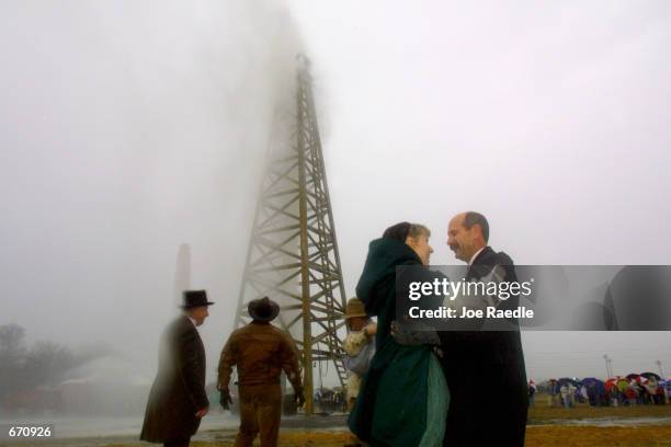 Actors dance and celebrate in front of the derrick as they re-enact the Lucas gusher at the Centennial celebration just outside Beaumont, Texas,...