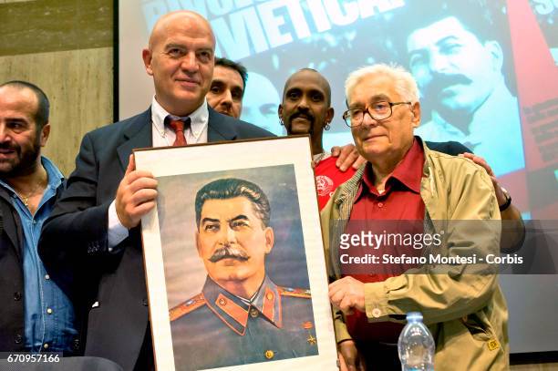 Marco Rizzo general secretary of the Communist Party displays a portrait of Joseph Stalin during the event International "Long Live The Soviet...