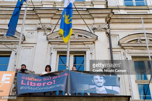 Chiara Appendino , mayor of Turin, shows a banner from town hall to demand freedom for Gabriele Del Grande during a rally to demand the release of...