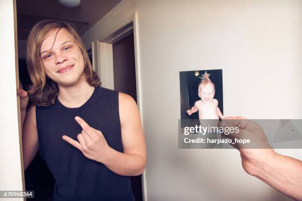 teenage boy next to a photo of himself as a toddler. - resistance to change stock pictures, royalty-free photos & images