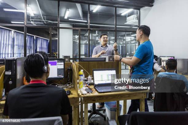 Rafizi Ramli, vice president of the People's Justice Party , speaks to an employee in the call center of Invoke's office in Kuala Lumpur, Malaysia,...