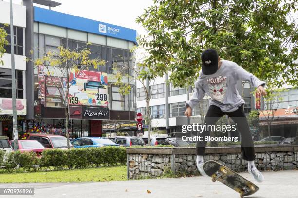 Skateboarder performs a trick near a building housing Invoke's office in Kuala Lumpur, Malaysia, on Tuesday, April 18, 2017. Invoke is a policy...