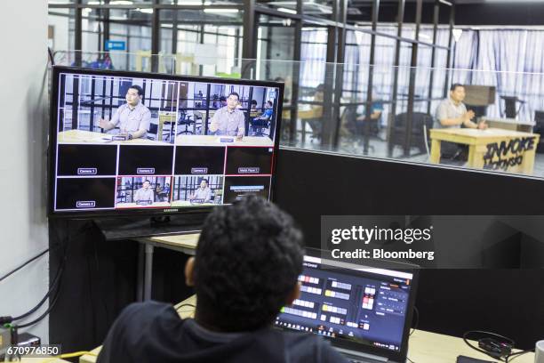 Employees monitor a Facebook Inc. Live video stream of Rafizi Ramli, vice president of the People's Justice Party , at Invoke's office in Kuala...