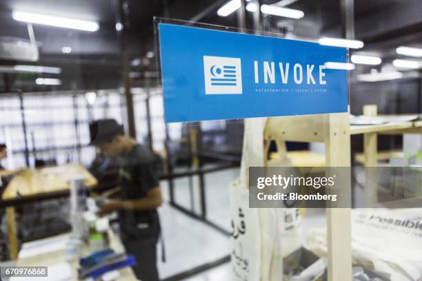 Signage for Invoke is seen pasted to a glass window at the company's office in Kuala Lumpur, Malaysia, on Tuesday, April 18, 2017. Invoke is a policy...