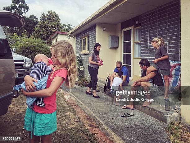two families relaxing at beach shack - australian family car fotografías e imágenes de stock