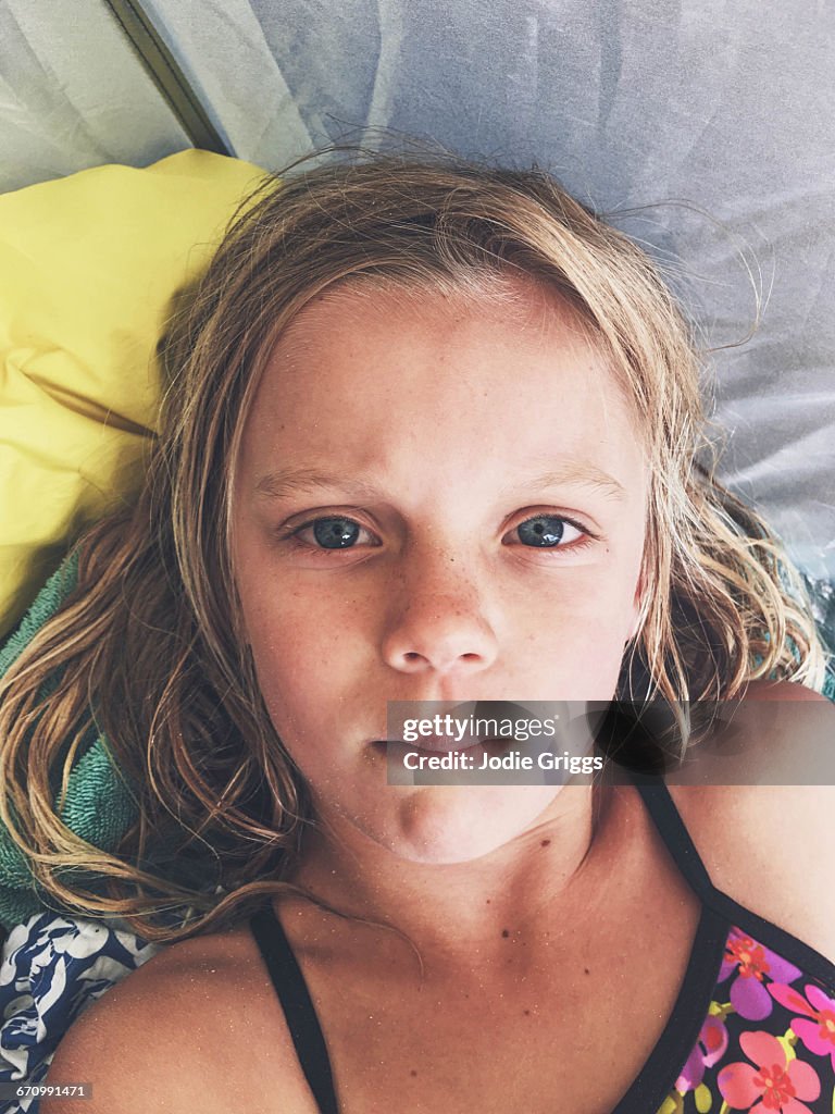Young girl with fat lip after being dumped by wave