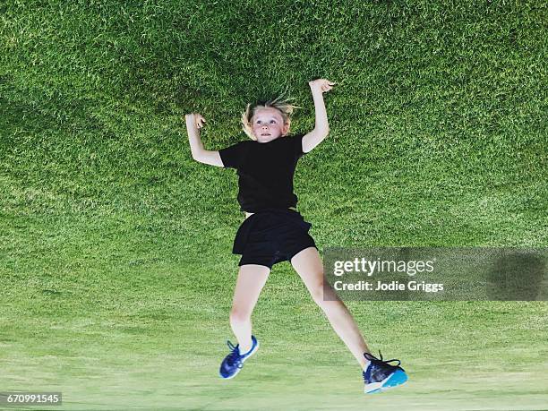 child doing a headstand on the grass - 逆さ ストックフォトと画像