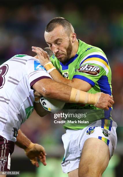 Nolan Stringer Josh Hodgson of the Raiders is tackled during the round eight NRL ...