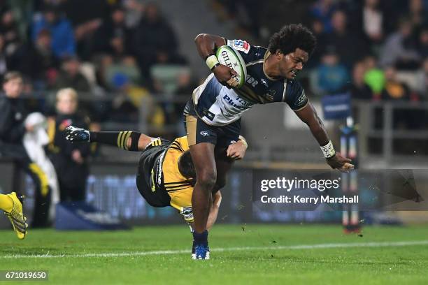 Henry Speight of the Brumbies is dragged into touch by Beauden Barrett of the Hurricanes during the round nine Super Rugby match between the...