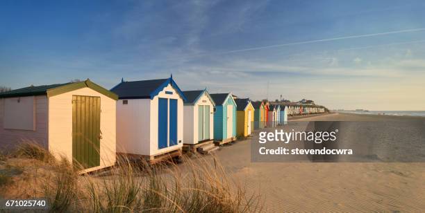 traditional wooden beach huts on the suffolk heritage coast of southwold. - beach pier stock pictures, royalty-free photos & images