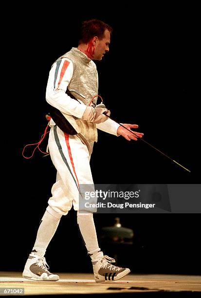 Jean-Noel Ferrari of France is stabbed in the neck September 22, 2000 during the Men's Team Foil Fencing event Gold Medal match victory over China...
