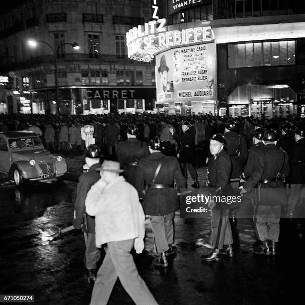 Police escort a demonstration of between 20,000 and 30,000 pro-Front de Liberation Nationale Algerians on October 17, 1961 in Paris. Later French...