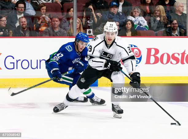 Drew Shore of the Vancouver Canucks checks Adrian Kempe of the Los Angeles Kings during their NHL game at Rogers Arena March 31, 2017 in Vancouver,...