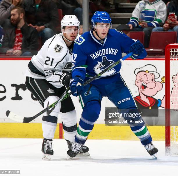 Drew Shore of the Vancouver Canucks is checked by Nick Shore of the Los Angeles Kings during their NHL game at Rogers Arena March 31, 2017 in...