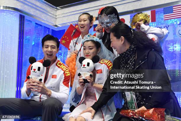 Shiyue Wang and Xinyu Liu of China react with their team mates at the kiss and cry after the Ice dance free dance during the 2nd day of the ISU World...