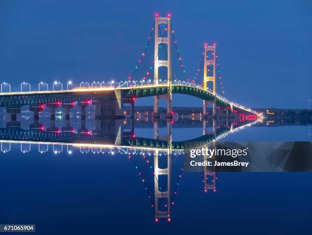 majestic mackinac bridge sparkles in deep blue predawn twilight. - mackinac bridge imagens e fotografias de stock