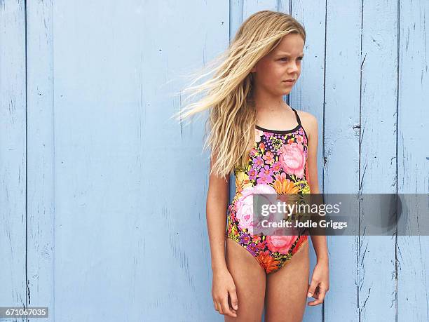 young girl in swimwear down at the beach - eendelig zwempak stockfoto's en -beelden