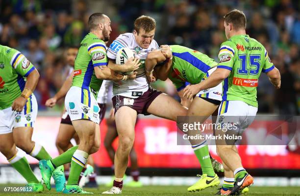 Jake Trbojevic of the Eagles is tackled during the round eight NRL match between the Canberra Raiders and the Manly Sea Eagles at GIO Stadium on...