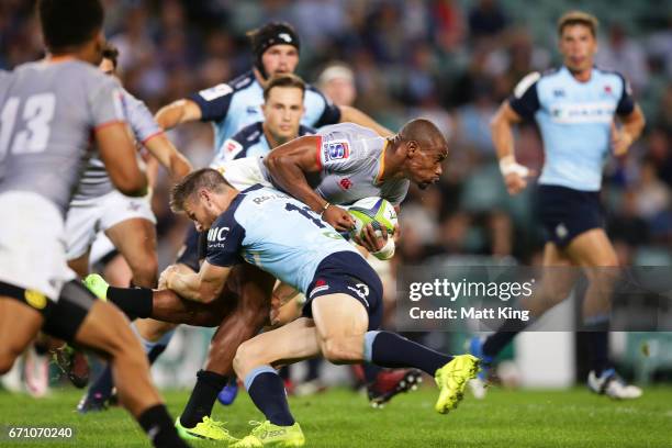 Luzuko Vulindlu of the Kings is tackled during the round nine Super Rugby match between the Waratahs and the Kings at Allianz Stadium on April 21,...