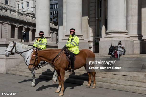 Mounted City Police officers make their presence known while on their horses in spring sunshine at Royal Exchange in the heart of the capital's...