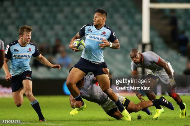 Israel Folau of the Waratahs is tackled during the round nine Super Rugby match between the Waratahs and the Kings at Allianz Stadium on April 21,...