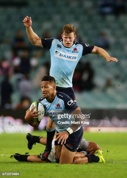 Israel Folau of the Waratahs is tackled during the round nine Super Rugby match between the Waratahs and the Kings at Allianz Stadium on April 21,...