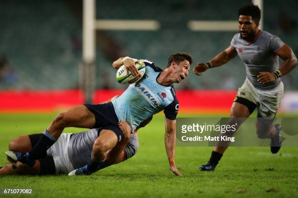Jake Gordon of the Waratahs is tackled during the round nine Super Rugby match between the Waratahs and the Kings at Allianz Stadium on April 21,...