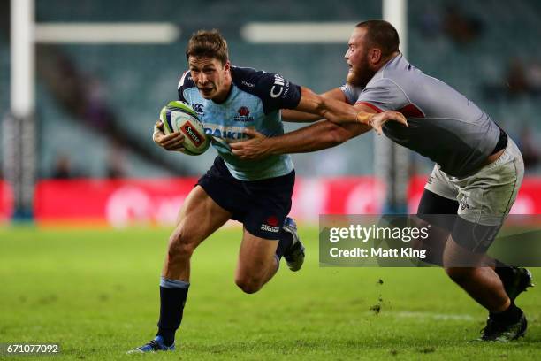 Jake Gordon of the Waratahs takes on the defence during the round nine Super Rugby match between the Waratahs and the Kings at Allianz Stadium on...