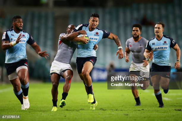 Israel Folau of the Waratahs is tackled by Makazole Mapimpi of the Kings during the round nine Super Rugby match between the Waratahs and the Kings...