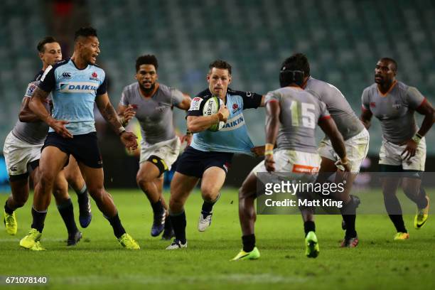 Bernard Foley of the Waratahs takes on the defence during the round nine Super Rugby match between the Waratahs and the Kings at Allianz Stadium on...